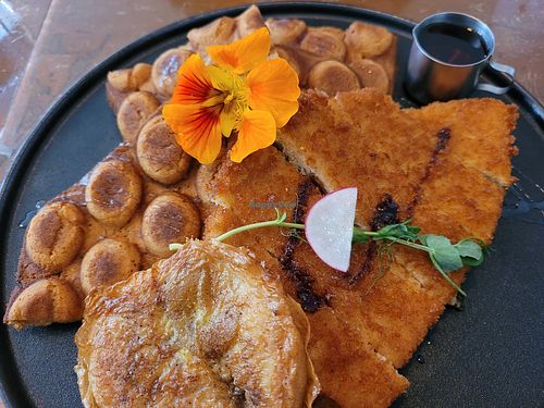 Incredibly delicious chicken with waffles. We got a bonus egg on the side and it was vile. at The Little Poet in Hobart