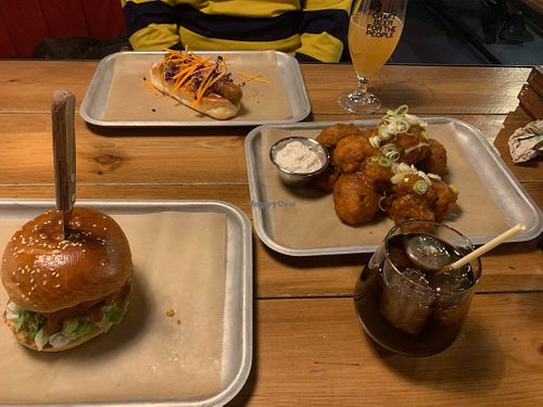 Vegan burger, vegan hotdog and temple of seitan cauliflower wings. Both drinks are vegan-friendly also (brewdog draught beer and rum + coke). at BrewDog in Budapest