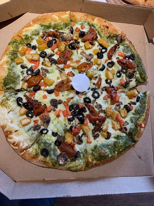 Vegan pesto margherita pizza with added olives, mushrooms and vegan chicken

 at Toppers Pizza in Sioux Falls