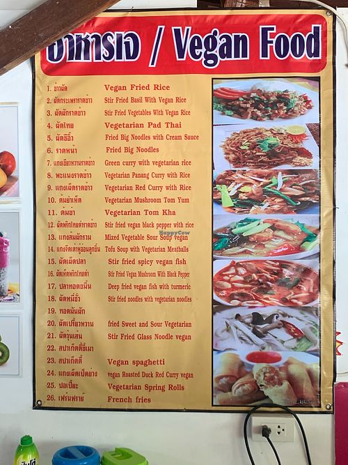 A wall poster displays a number of a-la-carte options at Tamachat Vegan Food - ธรรมชาติ in Koh Samui