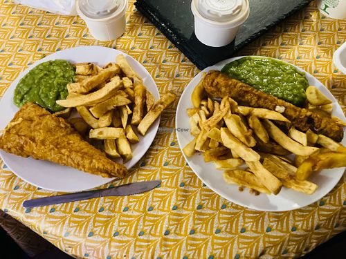 Tofu fish and chips with gravy and mushy peas, battered bratwurst with curry sauce and mushy peas. at JJ's Vish & Chips in Manchester