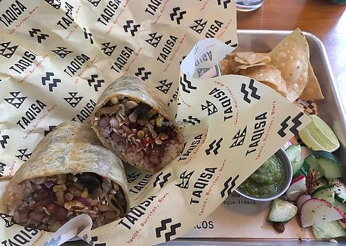 Vegan mushroom burrito with chips and green salsa at Taqisa in Denpasar