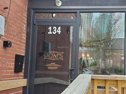 Side door With the name.  at Dom's in Winston-salem