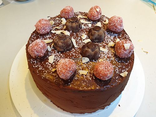 Vegan gluten-free, refined sugar-free chocolate cake with coconut cream filling and coconut truffles, caramel pralines, on-,order birthday cake at We Love Coffee in Leuven