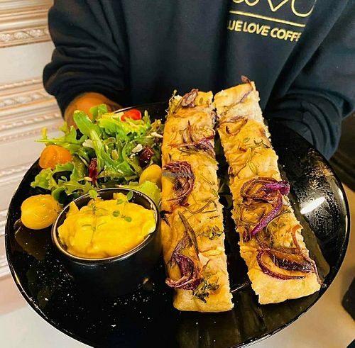 Fresh focaccia with salad and cheese sauce. Vegan! at We Love Coffee in Leuven