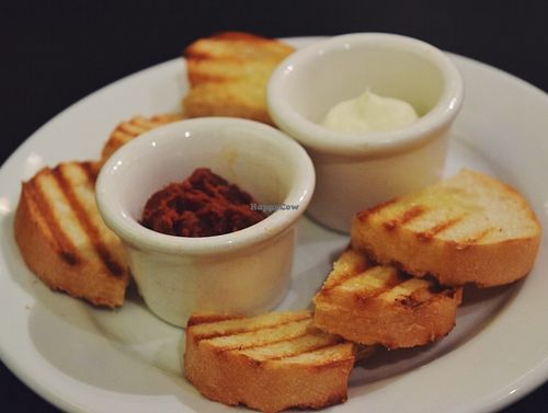 Bread plate with sundried tomato, the other isn't vegan at Eatcetera in Galveston