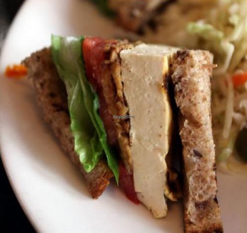 tofu club: Grilled tofu, tempeh bacon, lettuce and tomato on mixed grain toast with coleslaw, pickles and vegan mayo at Candle Cafe in New York City