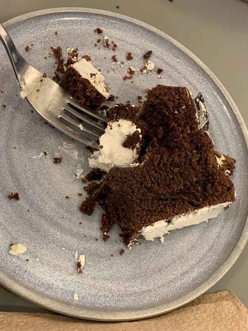 Chocolate brownie with whipped cream. at Bioma in Buenos Aires