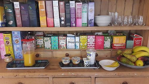 sorts of tea, cornflakes, fresh juice, fruits and soy joghurt at Claymore Vegetarian Guest House in Edinburgh