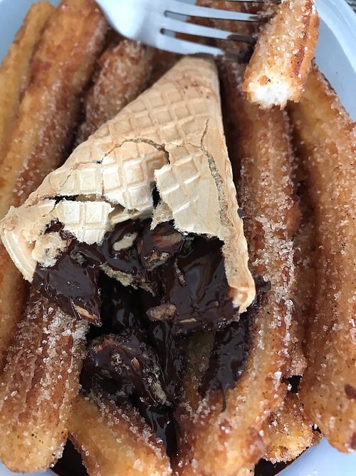 Cinnamon sugar churros with chocolate sauce in a cone holder - I packed it all in tupperware to carry it back across town, which is why the cone is crushed at Die Churreria in Leipzig