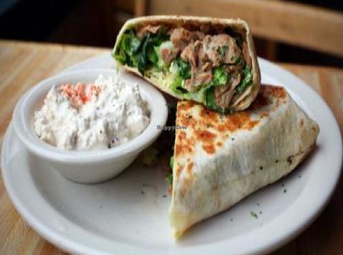 chiggen caesar wrap: soy chicken strips, romaine, tomato and onion with Caesar dressing. with a side of cottage cheez at Highline Bar in Seattle