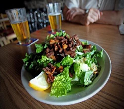 caeser salad: romaine, red onion, croutons, and caeser dressing. with soy chicken. at Highline Bar in Seattle