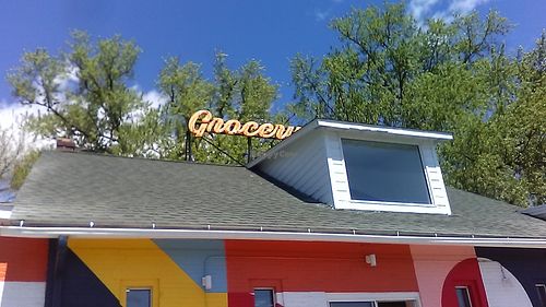 The roof and upper front wall of Village Grocery and Distillery in Kingston, NY, May 1, 2021. Picture by FoodFirst. at Village Grocery and Refillery in Kingston