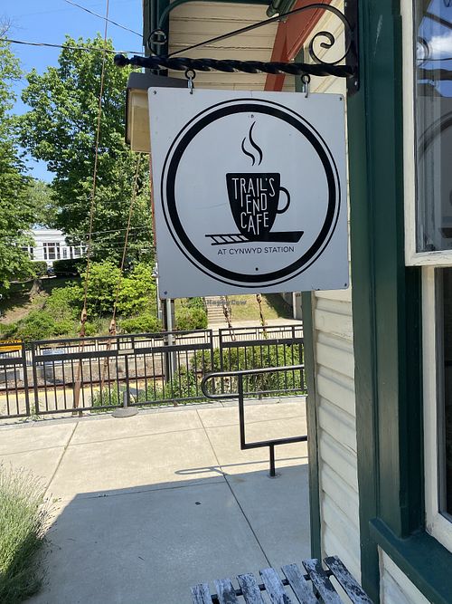 The trails end cafe sign with the railroad in the background   at Trail's End Cafe in Bala Cynwyd