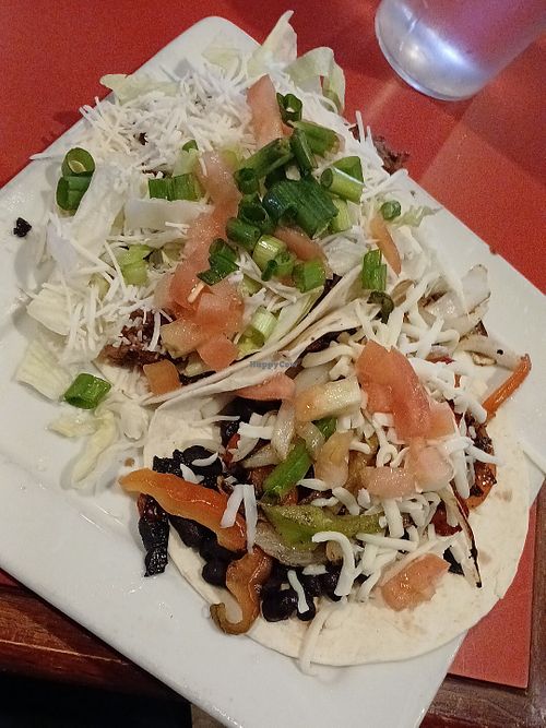 Beyond Taco w/ plant-based meatless meat, vegan cheese, lettuce, tomato, onion and Black Bean Taco* w/ fajita veggies, tomato, *sub vegan cheese  at Salty Iguana in Independence