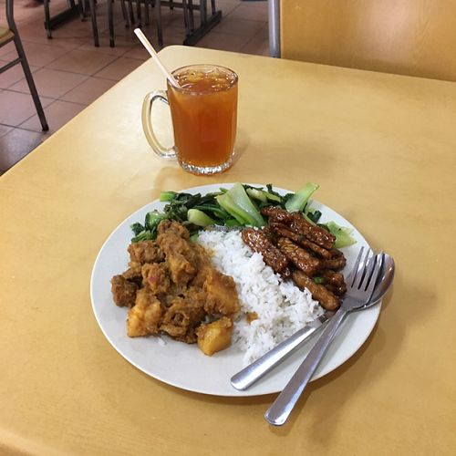 iced lemon tea and rice with tempeh, greens and curry at Loving Garden in Seri Kembangan
