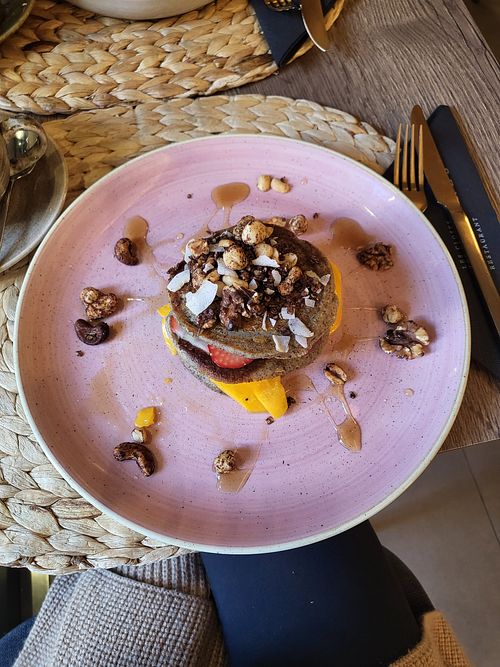 Buckwheat pancakes with strawberries, mango, candied nuts at Noranta Tres in Escaldes-engordany