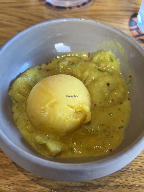 Mango sorbet with warm bananas in a coconut curry saucee  at Three House Hotel & Gastrobar in Funchal