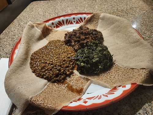 3 vegetable combo with misr wat, mustard greens,  and mushrooms. at Queen of Sheba in Portland