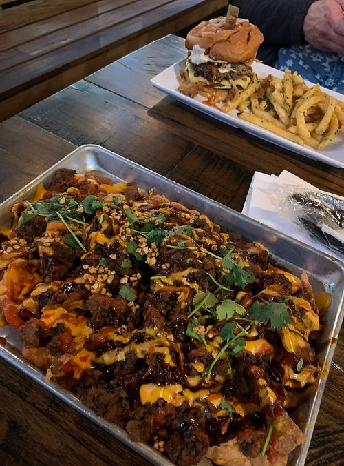 Viet-nachos (front) and blue cheese burger (back) as part of Houston Sauce Company night menu  at Mo' Brunch + Brews in Houston