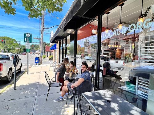 R2R Entrance with visitors from Colorado enjoying the views of Pleasantville NY. Yo! Really lovely small town friendly shopping vibes and a very cool bike shop is close bt. at Root 2 Rise in Pleasantville