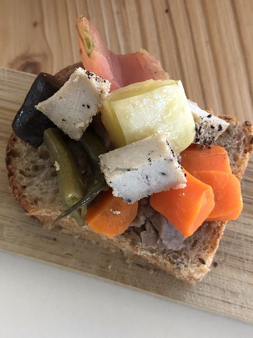 Vegan crostino with vegan pepper cheese, bean hummus and vegetables  at Integraldo in Majano