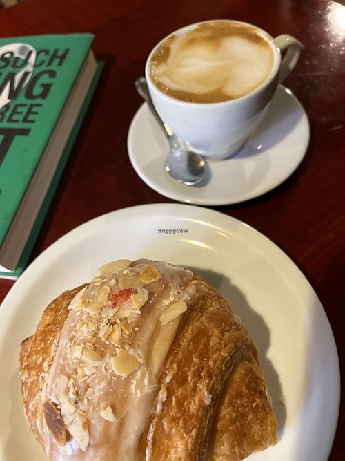 Oat cappuccino and almond croissant   at Massolit Books & Café in Krakow