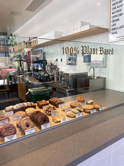 Signage on Point 100% Plant Based 🌱🥰✨  at Timeless Coffee - Webster in Oakland