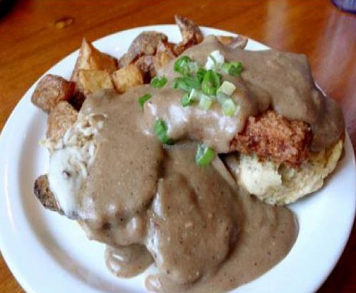 sloppy biscuit sandwich: fried tofu, faux turkey, vegan cheese and gravy between a vegan biscuit served with potatoes. at Cafe Gertrude in Portland
