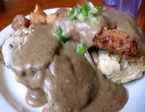 sloppy biscuit sandwich: fried tofu, faux turkey, vegan cheese and gravy between a vegan biscuit served with potatoes. at Cafe Gertrude in Portland