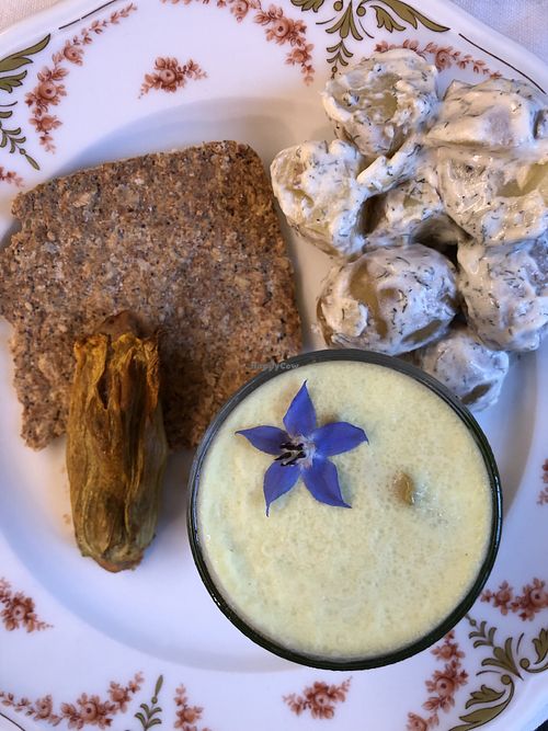 Homemade raw cracker with filled pumpkin flower, Finnish potato salad, and faux-gras at Koivu in Valchiusa