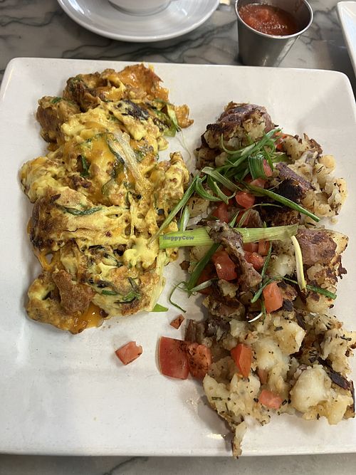 Seasonal vegan scramble. Three-“eggs” with cheese. Great potatoes    at Naked Cafe in Carlsbad