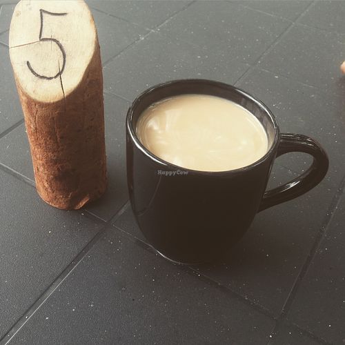 Enjoying my coffee while waiting for my meal to come at 13th Ave Coffee House in Regina