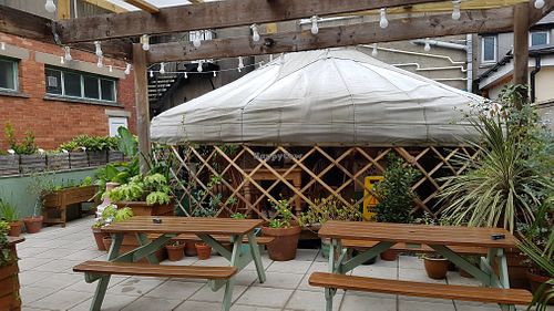 Outer area overlooking the yurt that also has tables inside  at Eartha in Cardiff