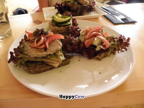 Smorrebrod Plate with three types of smorrebrod(left-right):

Portobello paté with pickled red onions, lentilburger with pickles and parsleycreme with pickled red onions.  at simpleRaw - Oehlenschlaegersgade in Copenhagen