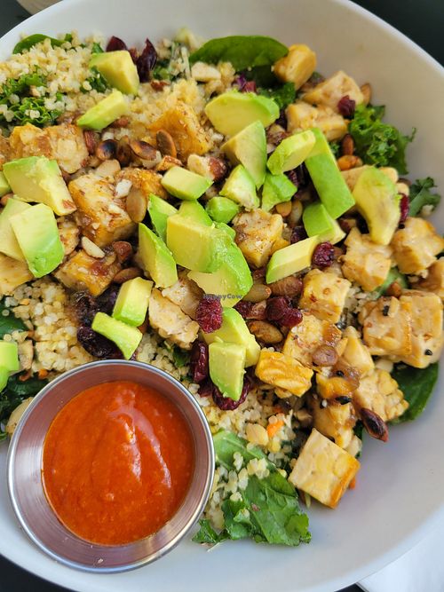 Cali Tempeh power bowl with red dressing on the side at Veggie Grill by Next Level in Santa Monica