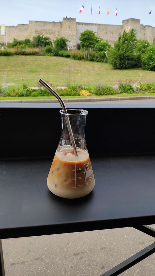 Cappuccino with the castle in the background at Arbuste in Caen