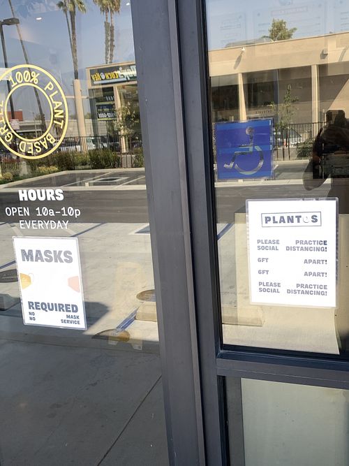 Door signage on restaurant entrance  at Plantos in Riverside