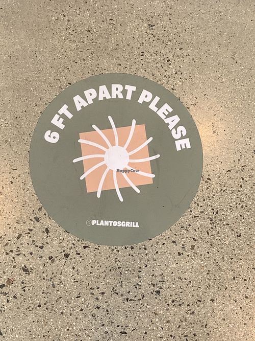 Social distancing stickers on the ground inside restaurant  at Plantos in Riverside