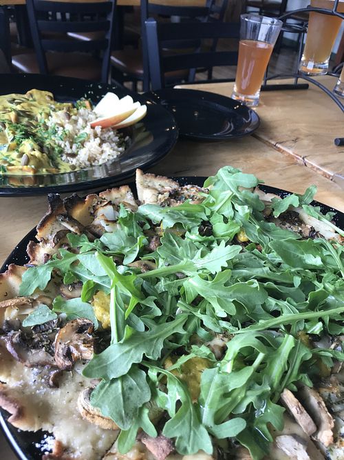 Mushroom flatbread and yellow curry with a kombucha flight!  at Julia's Vegetarian Restaurant in Pacific Grove