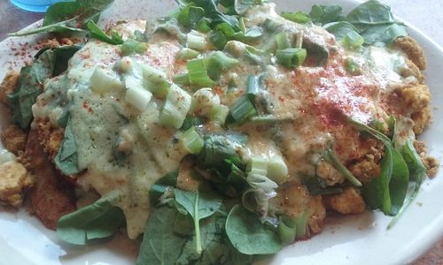 The Renedict, made vegan. Grilled ciabatta roll cut in two topped with fresh spinach, tofu scramble, slices of house tofu bacon, vegan Hollandaise and scallions.  at Bouldin Creek Cafe in Austin