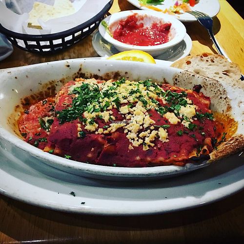 Vegan lasagna, and tortilla chips & sauce in the background. at Mother's Cafe and Garden in Austin