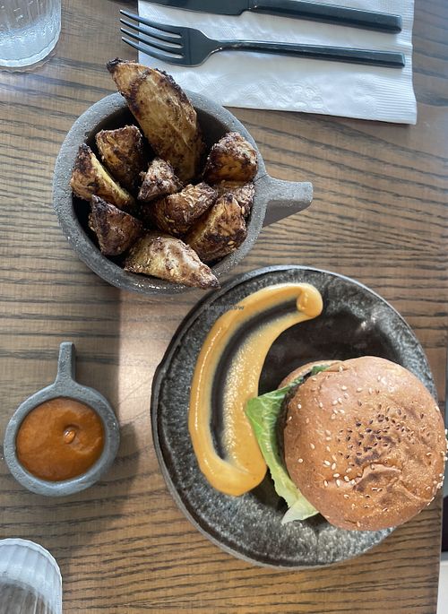 Neat burger w. Potato wedges   at Thalatheen  in Doha