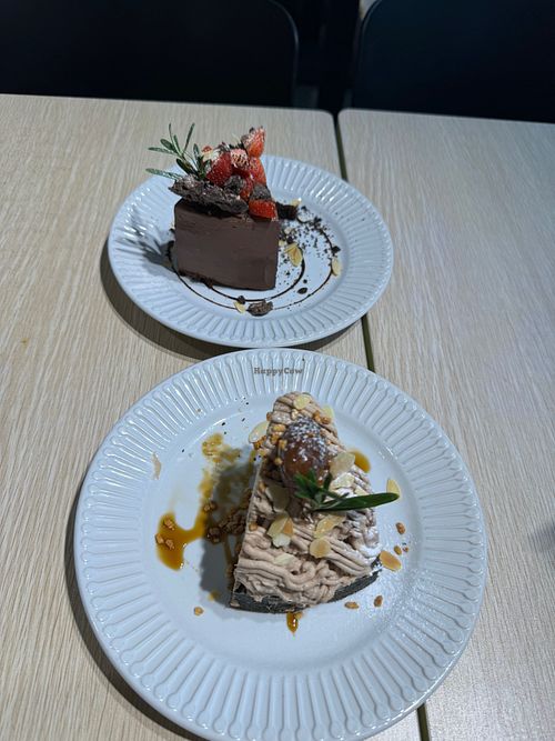 Chocolate cake (top) and chestnut cake (bottom) with a bite already taken out of them😅 at Root Vegan - 本原純素 in Hong Kong Island