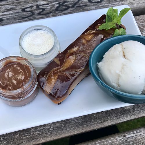 Vegan caramel and chocolate torte with melted chocolate sauce, cream and vanilla ice cream.  at The Whyte Harte Hotel in Bletchingley