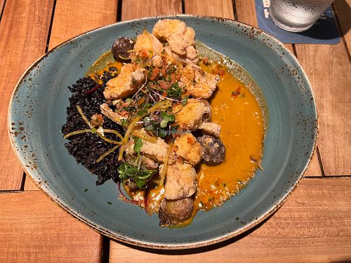 Aloo gobi main (second course) with delicately crisp cauliflower and marble potatoes, coconut purple rice, and curry sauce at Beach House by Roy Yamaguchi in Kahuku
