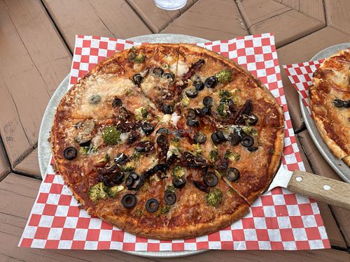 Gluten free base, vegan cheese, olives, sun-dried tomato and broccoli   at Rising Sun Pizza Company in St Mary
