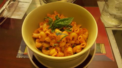 House-made vegan + gluten free mac 'n' cheese - corn pasta, sauce made from tomato and mango, topped with basil at Peace n Loaf in San Juan