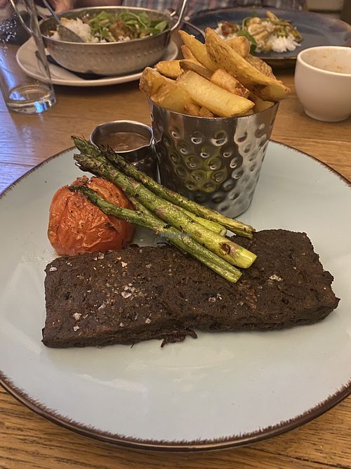 vegan steak with peppercorn sauce, asparagus, tomato, and chips  at The Douglas Hotel in Isle Of Arran