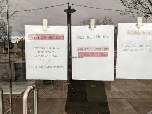 2021 store hours posted at entrance at RawASF in Fremont